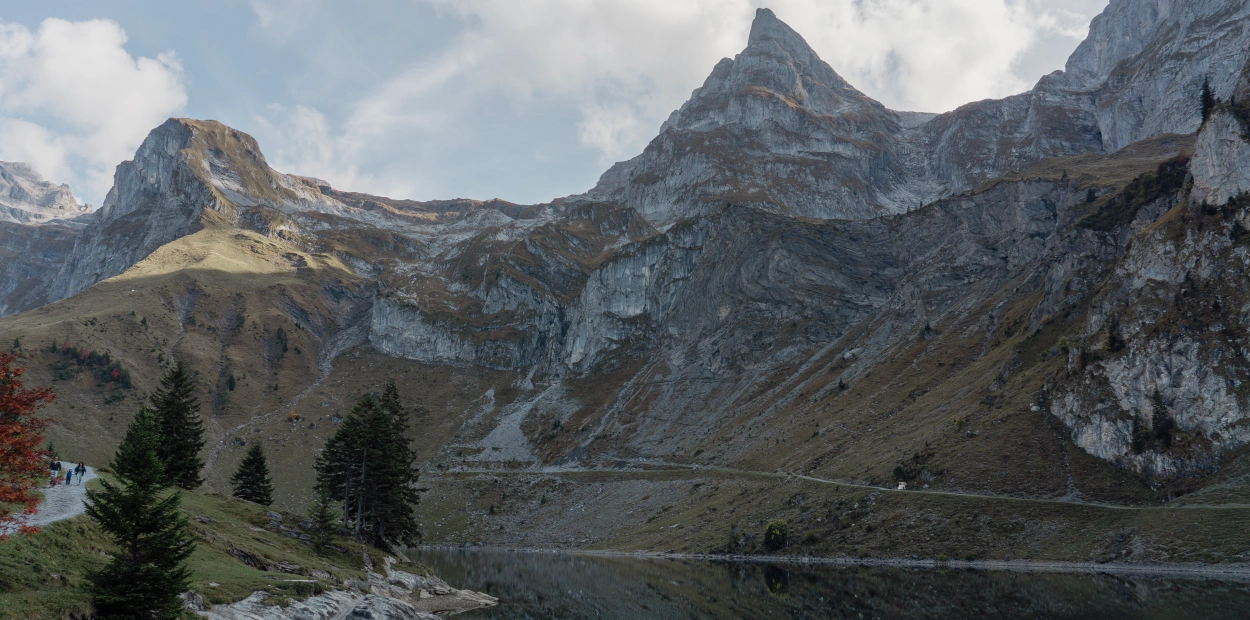 Explore the stunning alpine lake surrounded by majestic mountains in Wolfenschiessen, Switzerland.